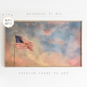 May include: A framed painting of an American flag waving in a cloudy sky. The sky is a mix of pink, blue, and white. The painting is in a gold frame. The text "Aesthetic Tv Art" is above the painting and the text "Premium Frame Tv Art" is below the painting.