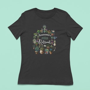 May include: Black t-shirt with a white graphic of a circle of potted plants and the text "GARDENER'S Retreat".