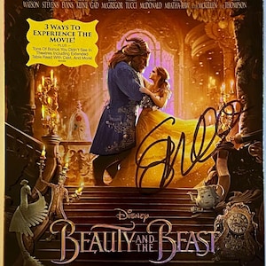 May include: A Blu-ray DVD combo pack of the Disney film Beauty and the Beast. The cover features a golden yellow background with a portrait of Belle and the Beast dancing. The title "Beauty and the Beast" is written in gold lettering with a musical note design. The film stars Emma Watson, Dan Stevens, Luke Evans, Kevin Kline, Josh Gad, Ewan McGregor, Stanley Tucci, Audra McDonald, Gugu Mbatha-Raw, Ian McKellen, and Emma Thompson.