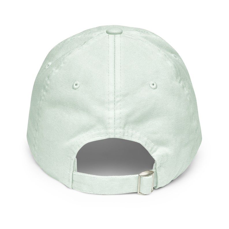 May include: A light green baseball cap with a buckle closure on the back.