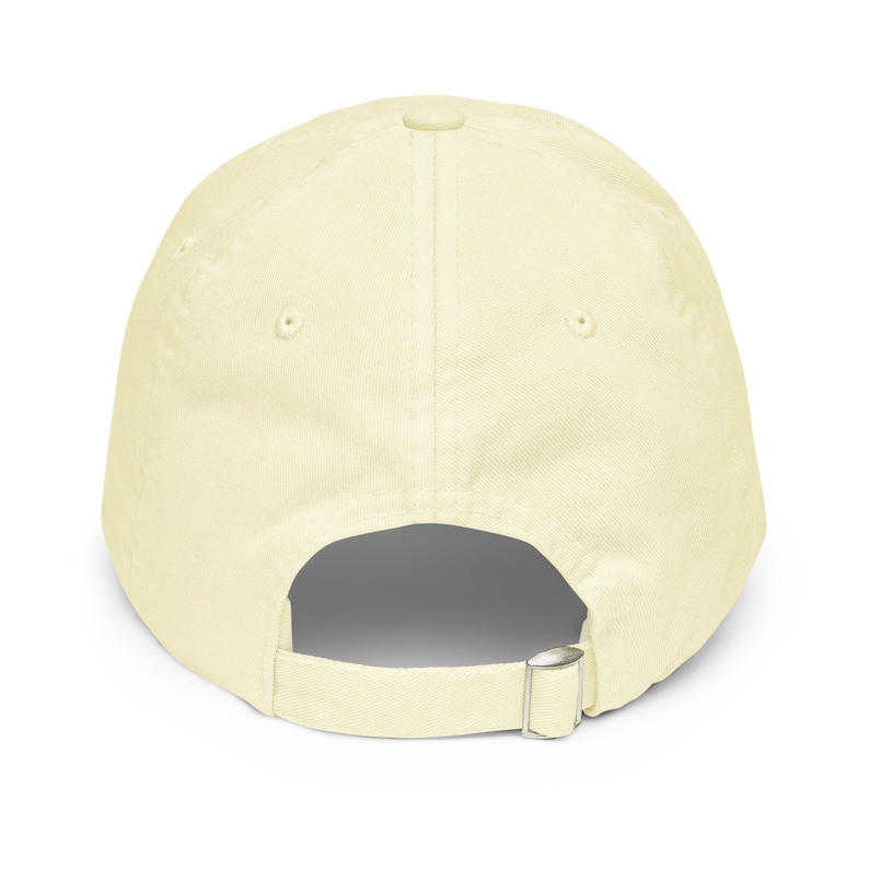 May include: A plain, light yellow baseball cap with an adjustable strap in the back.