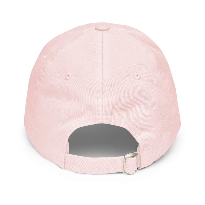 May include: A plain pink baseball cap with an adjustable strap in the back.