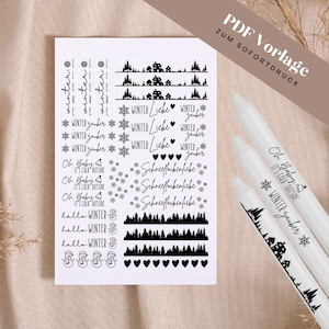 Op de afbeelding: Een vel met printbare stickers met winterse ontwerpen, waaronder sneeuwvlokken, bomen, huizen, harten en tekst in het Duits. De tekst omvat "Winter Zauber", "Winter Liebe", "Schneeflockenliebe" en "Oh Baby, It's Cold Outside".