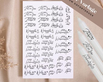May include: A white sheet with black text featuring holiday-themed words and phrases, including "Winter," "Christmas," and "Advent." The words are arranged in a decorative layout. Several white candles are visible in the image.