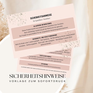 Könnte beinhalten: Drei rosa und weiße Karten mit deutschem Text, darunter "SICHERHEITSHINWEISE" und "VORLAGE ZUM SOFORTDRUCK". Die Karten haben ein Blumendesign und enthalten Sicherheitsinformationen für Epoxidharz und Kunstharz.