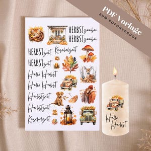 May include: A white pillar candle and a sheet of stickers with autumn-themed illustrations. The stickers feature images of a cat, mushrooms, a deer, a truck, and text that reads "Hallo Herbst" and "Herbstzeit".