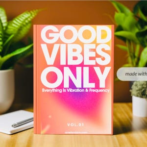 May include: A pink and orange notebook with the text "GOOD VIBES ONLY" in white. The text "Everything is Vibration & Frequency" is below the main text. The notebook also has the text "VOL. 01" on the bottom.