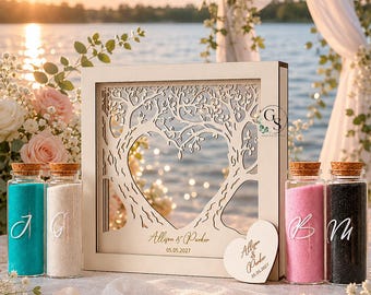 May include: A wooden wedding unity sand ceremony set. The set includes a decorative wooden frame with a tree design and heart-shaped cutout, personalized with names and a date. It also features glass bottles filled with colored sand.