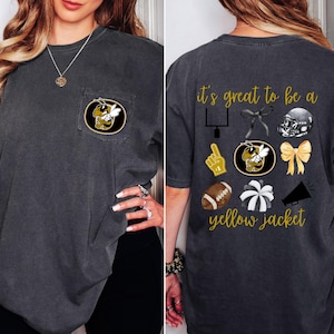 May include: A black t-shirt with a pocket on the left side featuring a yellow jacket mascot. The back of the shirt has the text "it's great to be a yellow jacket" with various sports-related icons.