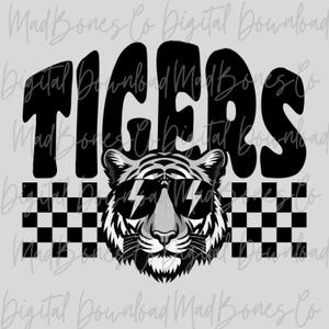 May include: A black and white graphic design featuring the word "TIGERS" in bold letters above a tiger wearing sunglasses with lightning bolt lenses. A checkered pattern is below the tiger.