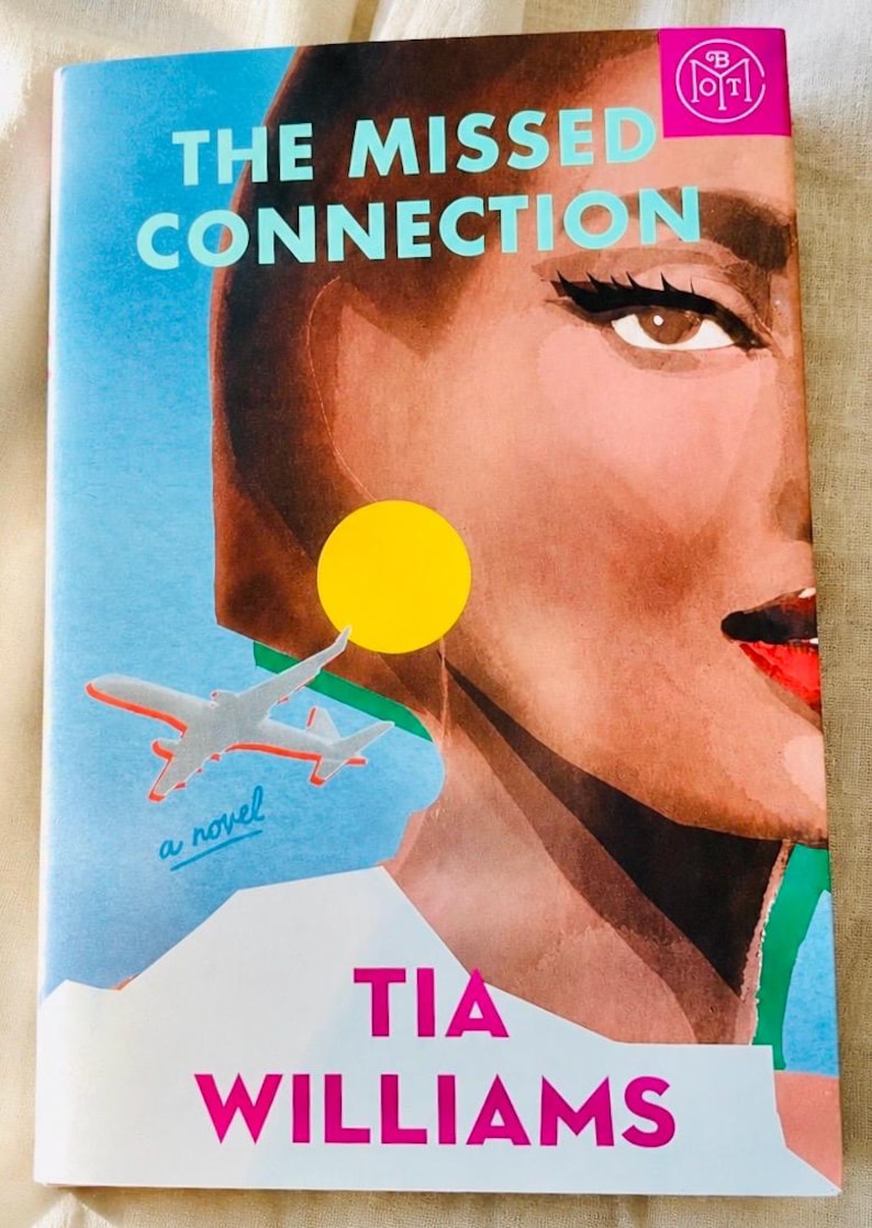 May include: A book cover titled The Missed Connection by Tia Williams. The illustration features a close-up of a person's face with dark hair, winged eyeliner, and red lips. A small grey airplane, a yellow circle, and the text a novel are visible.