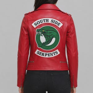May include: A red leather jacket featuring a large embroidered patch on the back. The patch displays a green snake coiled in a circle with the text SOUTH SIDE in an arch above and SERPENTS in an arch below, both in black lettering on white.