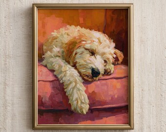 May include: A framed painting of a sleeping Goldendoodle dog. The dog is light brown and cream-colored, resting on a pink cushion. The painting has a gold frame and is set against a neutral background.