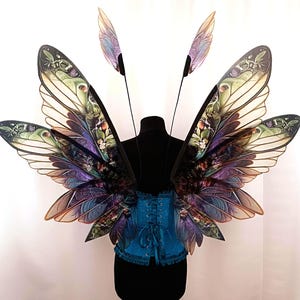 Large green wings of a woodland fairy with a floral pattern for Adult Ren Faire Costume