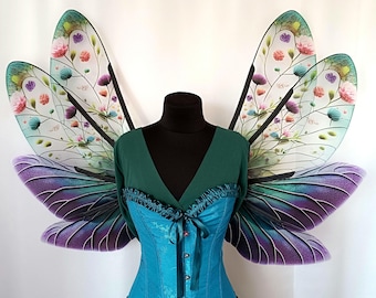 Transparent plastic wings of a forest fairy with a floral pattern