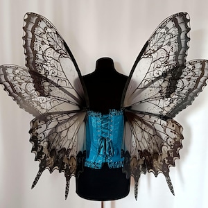 Large black gothic wings with lace patterns for a fairy costume for a Renaissance ball.