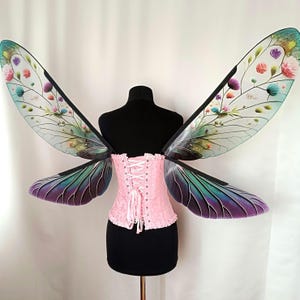 Transparent beetle wings with a floral pattern for an adult carnival costume.
