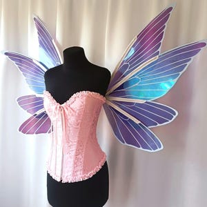 Purple iridescent wings of a magic butterfly with a white outline.