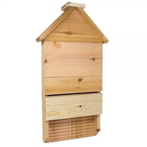 May include: A wooden house-shaped insect hotel with multiple compartments for different types of insects. The hotel has a pitched roof and a small opening at the bottom.