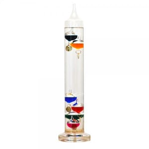 May include: A clear glass thermometer with a round base and a long, cylindrical body. The thermometer contains a clear liquid with four colored glass balls inside: blue, red, orange, and green.