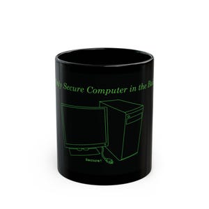 May include: A black ceramic mug featuring a green line-art illustration of a desktop computer and monitor. The text "Only Secure Computer in the Building" is printed in green above the computer, with the word "Secure!" printed below the power cord.