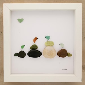 framed sea glass artwork, framed rock art,  colorful sea glass birds sitting atop colorful rocks with a heart shaped sun