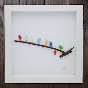 sea glass art, framed sea glass birds, colorful sea glass birds sit on top of a piece of driftwood