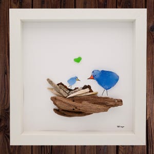 sea glass home decor, driftwood home decor, sea glass framed art, blue birds created from sea glass on a nest created from driftwood.