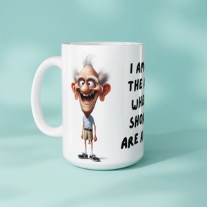 Image of a mug with a sublimation design for 11oz and 15oz sizes featuring a funny old man and the text I am at the age where shorts are a risk The mug is placed against a light blue background to show its physical look