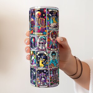 Person displaying a 20oz tumbler with a full wrap featuring sarcastic tarot card designs, ideal for unique sublimated drinkware.