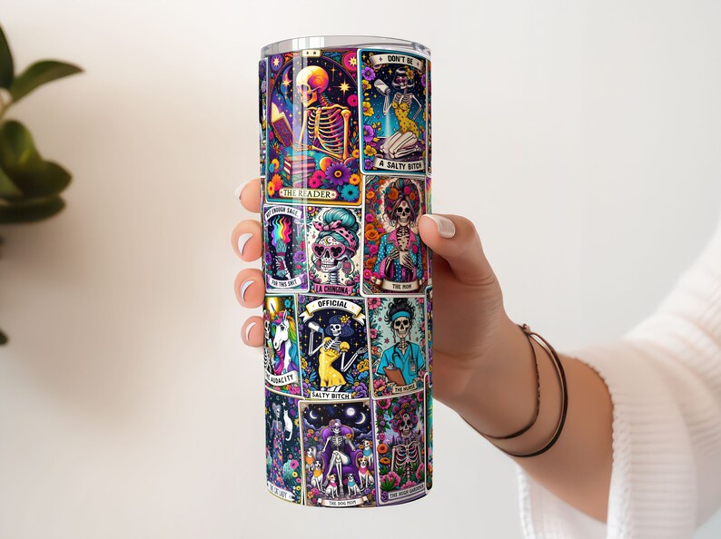 Person displaying a 20oz tumbler with a full wrap featuring sarcastic tarot card designs, ideal for unique sublimated drinkware.