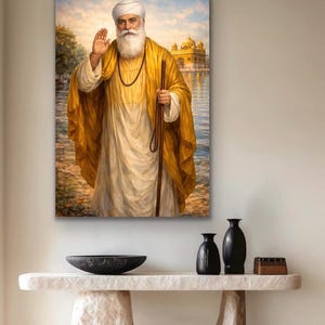 May include: A framed painting shows a man in a white turban and robe, with a long white beard, holding a staff. He is standing in water with a golden building in the background. The man is wearing a gold shawl.