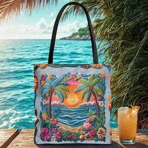 May include: A tote bag with a tropical beach scene featuring palm trees, flowers, and a sunset. The bag has a black handle and is on a wooden surface. A glass of orange-coloured drink with a garnish is next to the bag.
