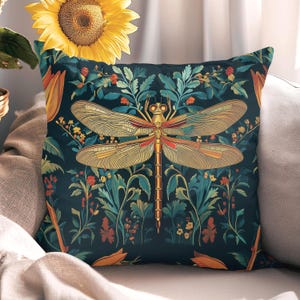 May include: A decorative cushion with a dark blue background featuring a gold and red dragonfly surrounded by green and yellow floral patterns.