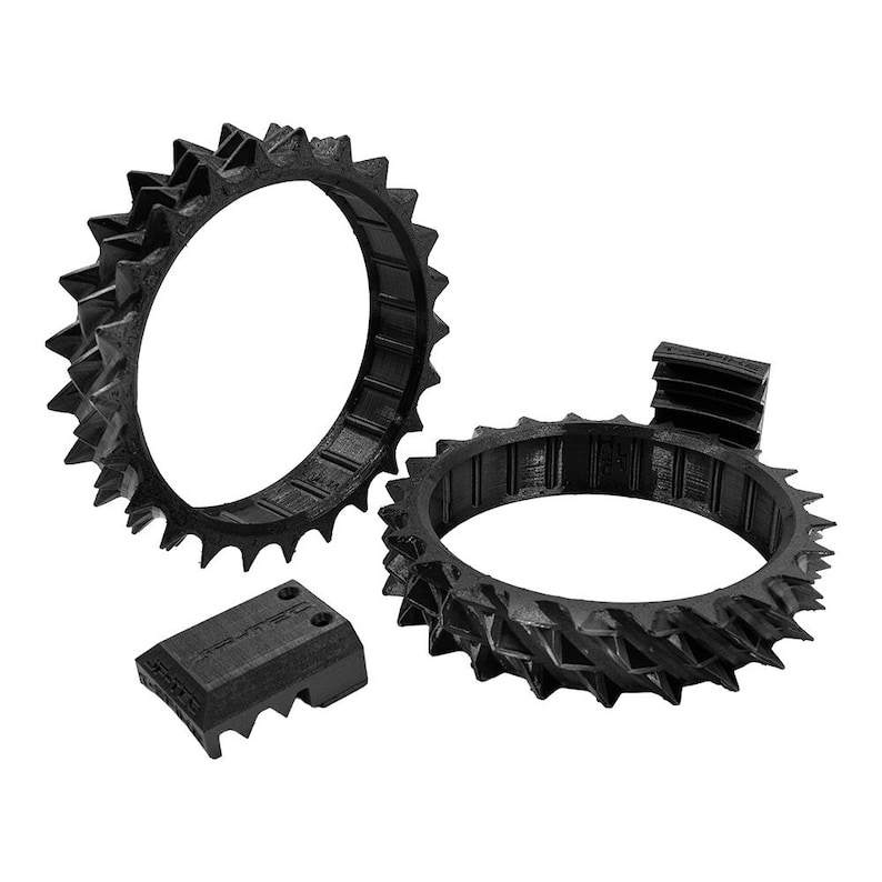 May include: Black, 3D-printed components, including two spiked rings and a rectangular piece. The rings have a series of sharp, triangular protrusions around their outer edges. The rectangular piece has a similar spiked design on one side.