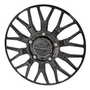 May include: A black car wheel with a complex, open spoke design. The wheel features a central hub with the letters "SC" and a series of bolts around the center. The wheel's design includes multiple triangular and curved elements.