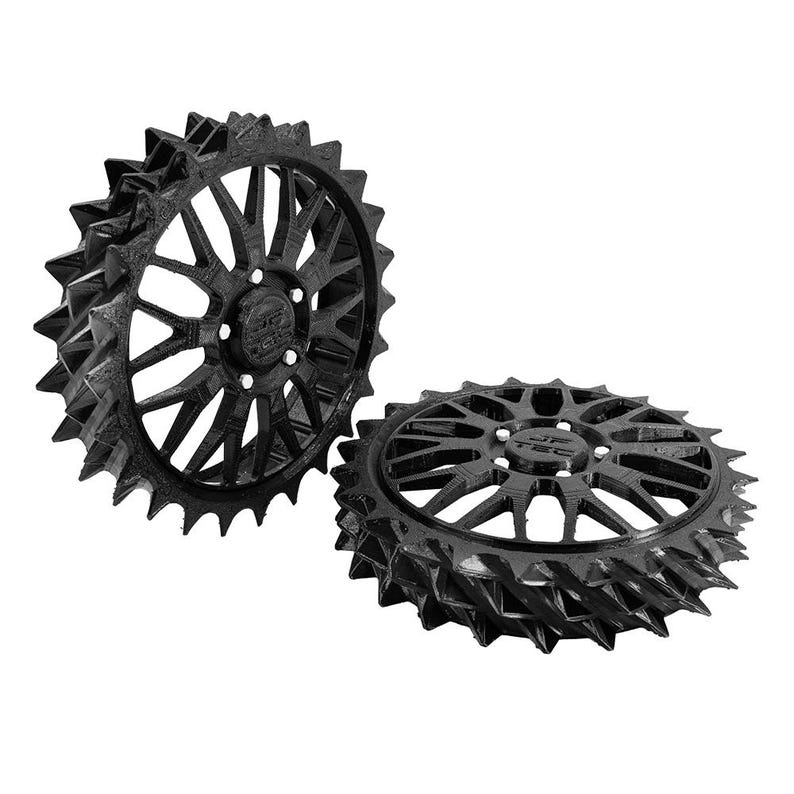 May include: Two black, spiky, gear-shaped objects. Each gear has a central hub with the text "JP TEC" and multiple spokes radiating outwards. The outer edge of each gear is lined with sharp, triangular protrusions.