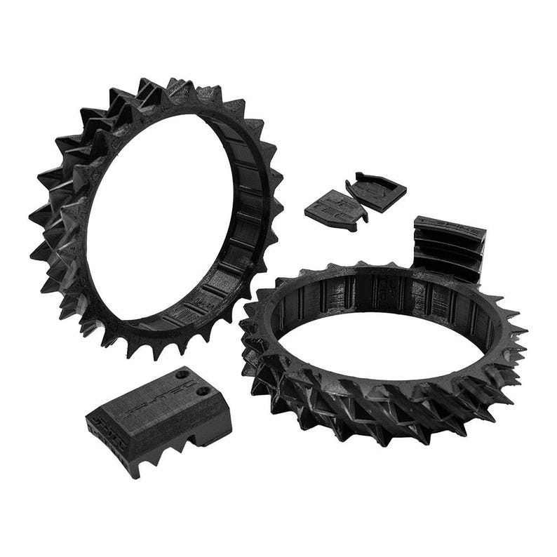 May include: Black, 3D-printed gear components. The image shows two spiked rings, two smaller rectangular pieces, and two additional components. The gear rings have a series of triangular spikes around the outer edge. The components are designed for mechanical applications.
