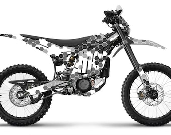 May include: A black and white electric dirt bike with a honeycomb pattern design. The motorcycle has large, knobby tires, a black seat, and a front headlight. The bike is designed for off-road use.
