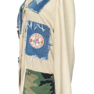 May include: Beige jacket with denim patches and a camouflage pocket. The jacket features frayed denim accents on the collar and patches. One patch has the text "WHAT IF IT ALL WORKS OUT?" in a circular design with a rose.