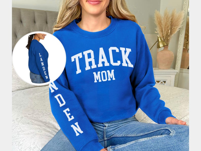 May include: A royal blue sweatshirt with the text "TRACK MOM" in white on the front and the name "LANDEN" in white on the sleeve.