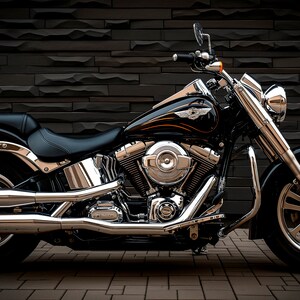 May include: A black and chrome motorcycle with a large engine and a single seat. The motorcycle is parked in front of a black brick wall.
