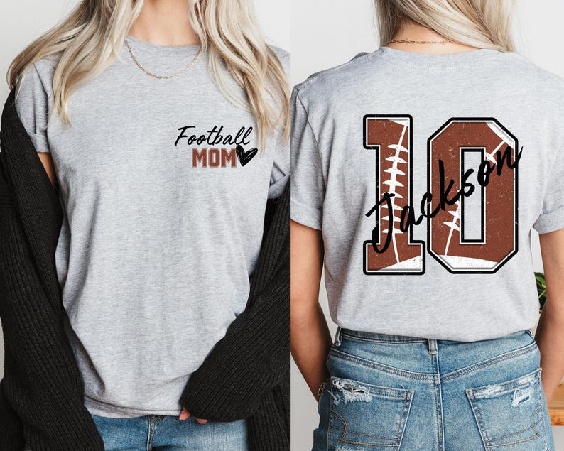 May include: Two gray t-shirts with a football theme. One shirt says "Football Mom" with a heart. The other shirt has a brown football jersey number "10" with the name "Jackson" written on it.