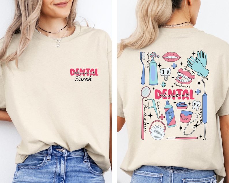 May include: A beige t-shirt with a pink and white design on the back. The design includes a variety of dental tools and the text "DENTAL ASSISTANT". The front of the shirt has the text "DENTAL Sarah" in pink.
