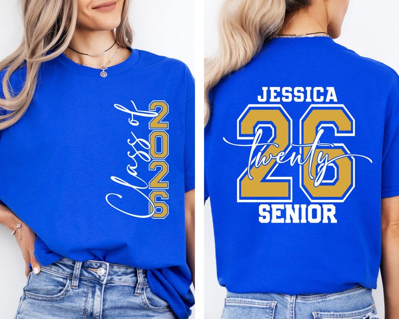 May include: Royal blue t-shirt with the text "Class of 2026" in white script and gold block letters. The back of the shirt features the name "Jessica", the number "26", and the word "Senior" in white and gold.