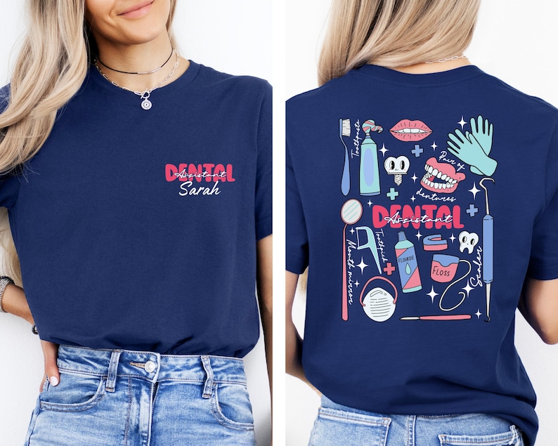 May include: A navy blue t-shirt with a pink and blue graphic design of dental tools and the text "Dental Assistant". The shirt also has the text "Dental Assistant Sarah" in pink.