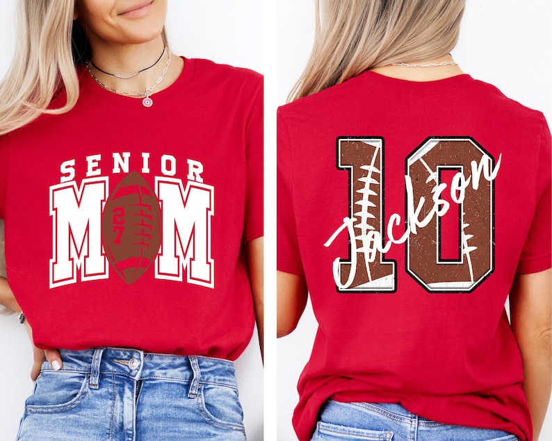 May include: A red t-shirt featuring a front graphic with the text SENIOR MOM and a football icon, and a back graphic with the large number 10, a football texture, and the name Jackson written in white script across the center of the number.