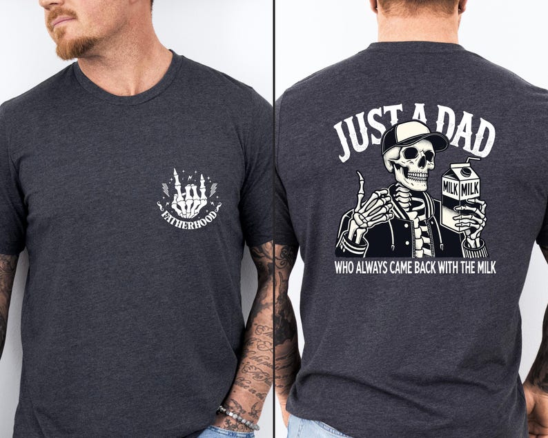 May include: Dark gray t-shirt with a white graphic on the front that says "FATHERHOOD" with a skeleton hand design. The back of the shirt features a skeleton wearing a hat and jacket, holding a milk carton, with the text "JUST A DAD WHO ALWAYS CAME BACK WITH THE MILK."