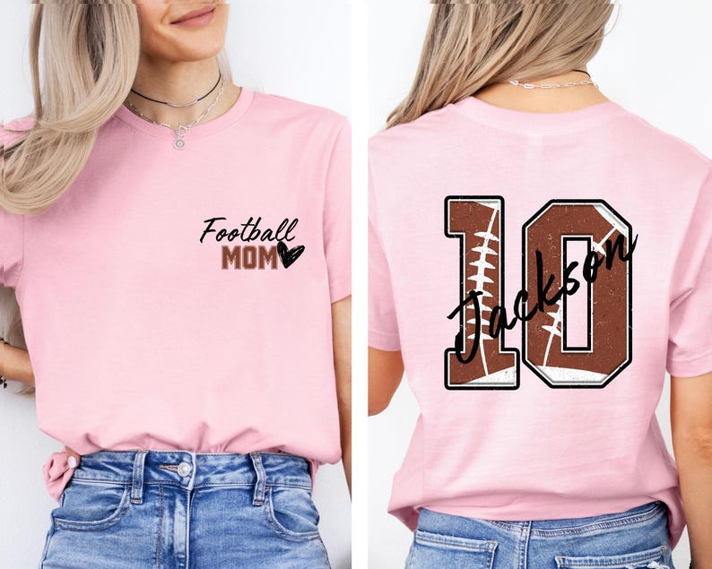 May include: Pink t-shirt with the text "Football Mom" and a heart on the front. The back of the shirt has a football-shaped number 10 with the text "Jackson" on it.