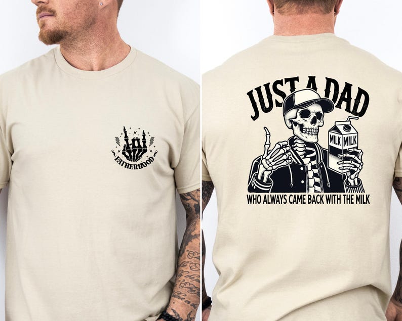 May include: Beige t-shirt with a skeleton graphic. The front features a skeleton hand design with the word "Fatherhood." The back displays a skeleton wearing a cap and holding a milk carton, with the text "Just a Dad Who Always Came Back With The Milk."